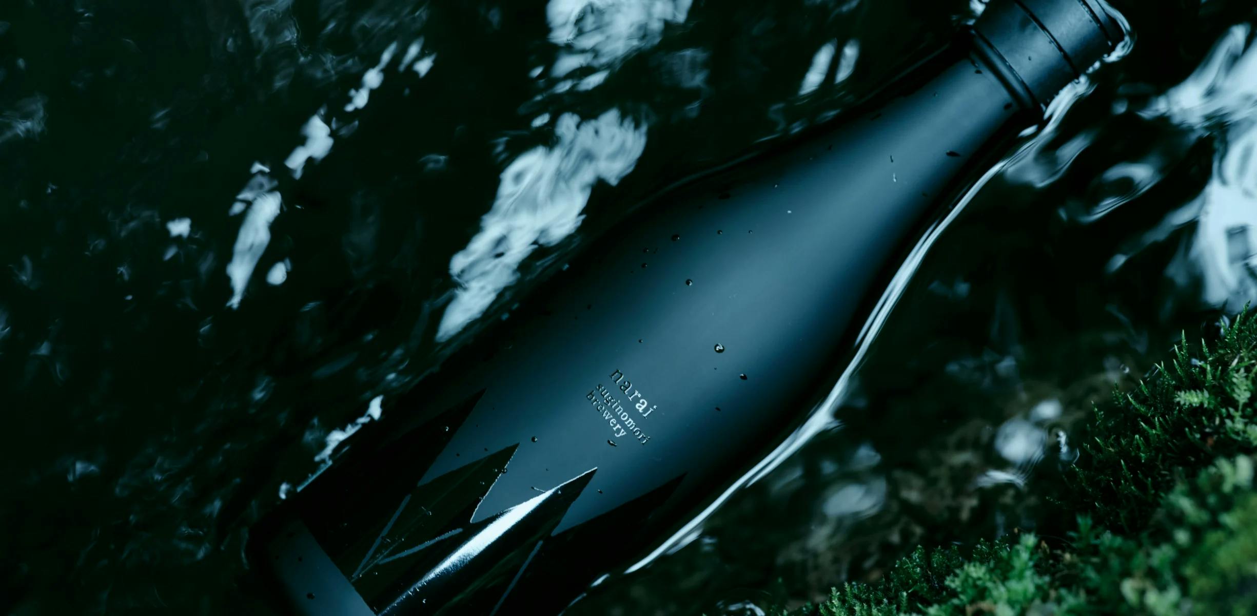 A picture of Narai Black bottle in a mossy creek.